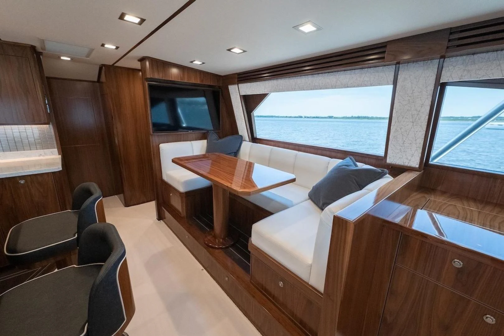 a room with a table and chairs aboard GAME ON Yacht for Sale
