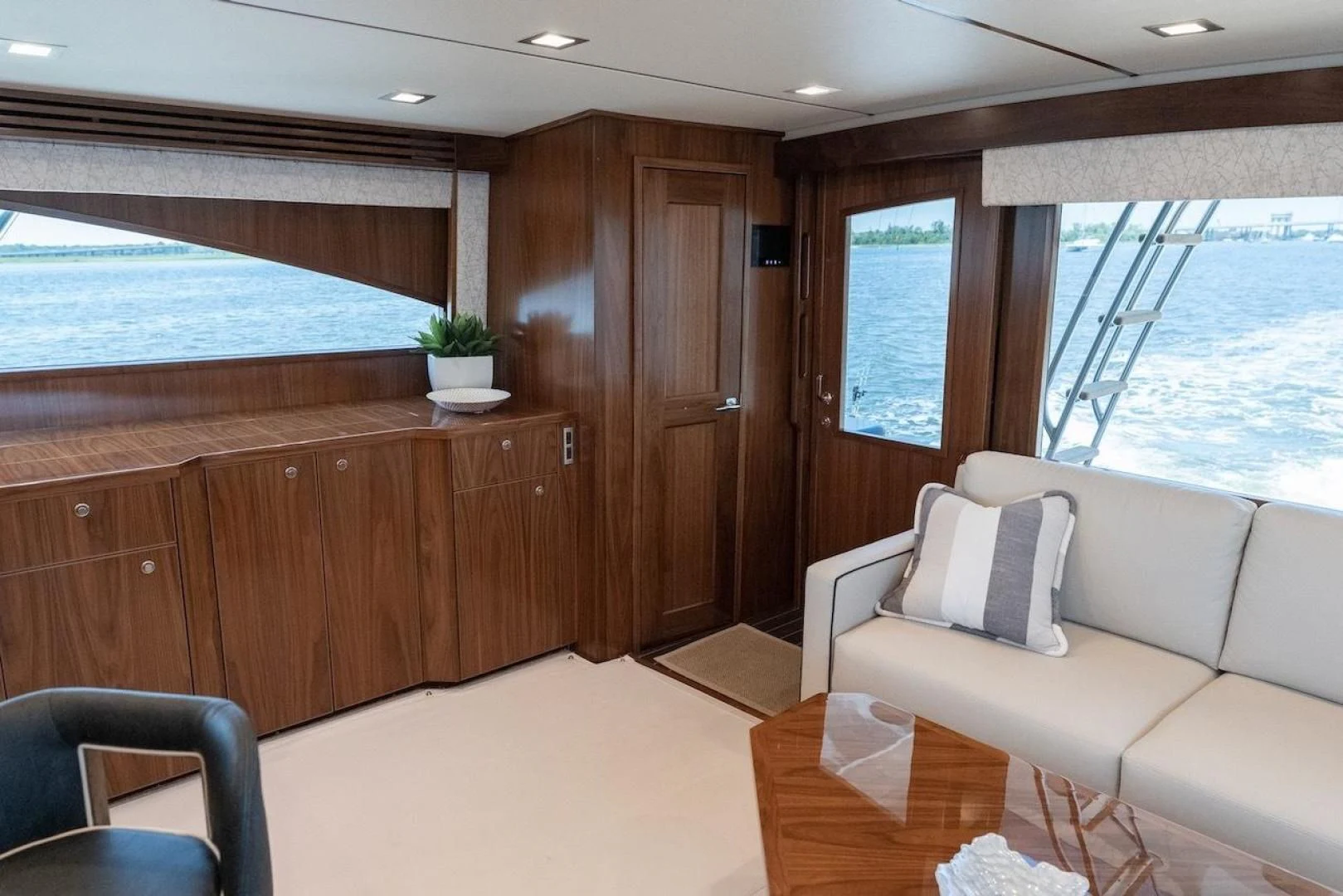 a room with a couch and a table and a window aboard GAME ON Yacht for Sale