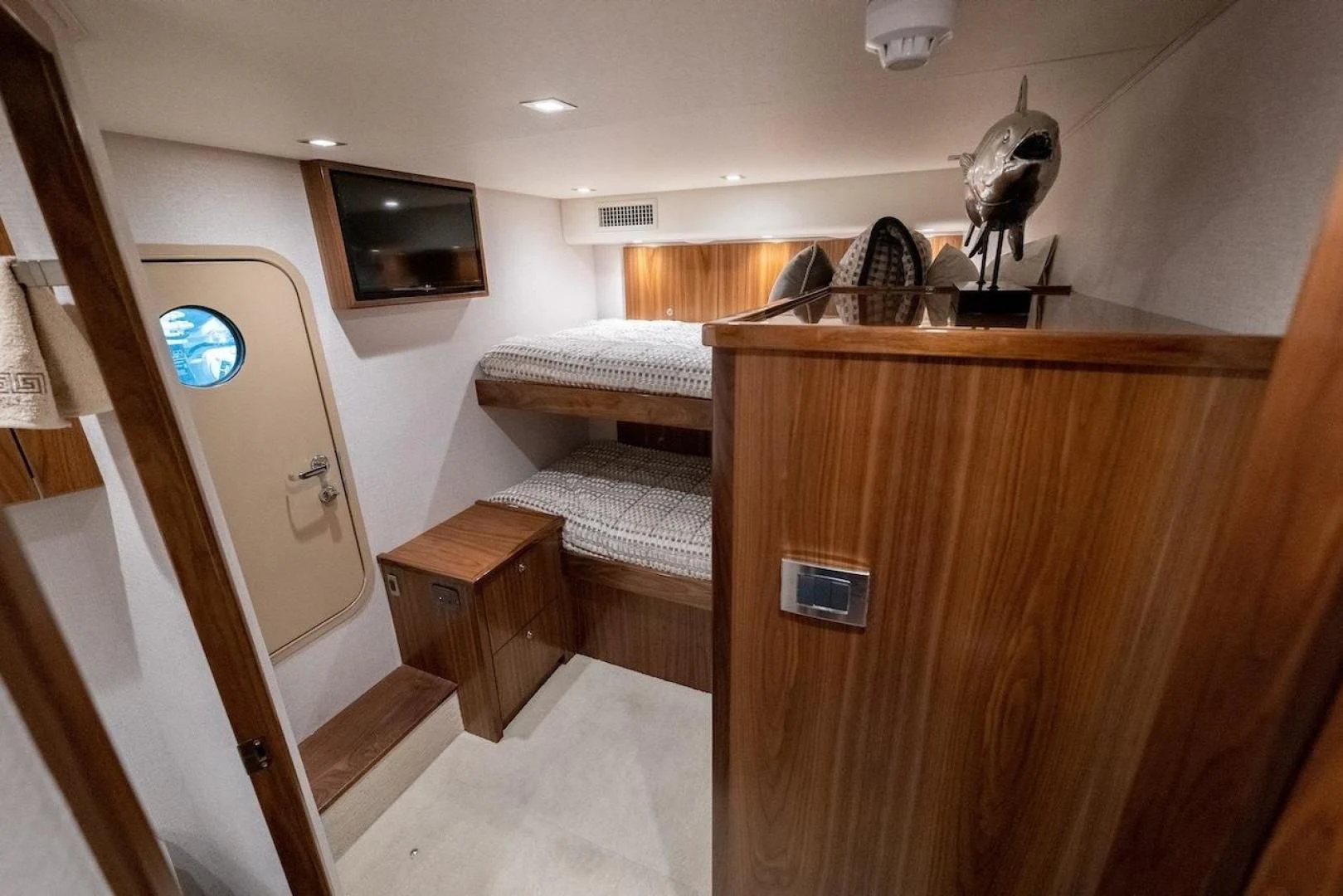 a room with a bed and a television aboard GAME ON Yacht for Sale