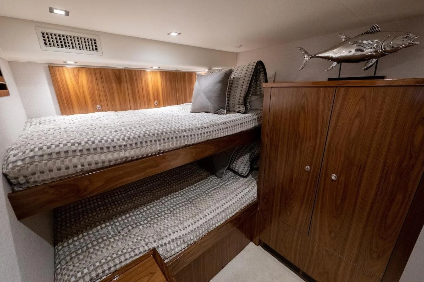 a bedroom with a bed and a table aboard GAME ON Yacht for Sale
