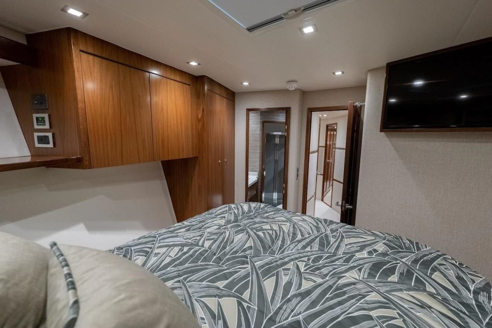 a bedroom with a bed and a television aboard GAME ON Yacht for Sale