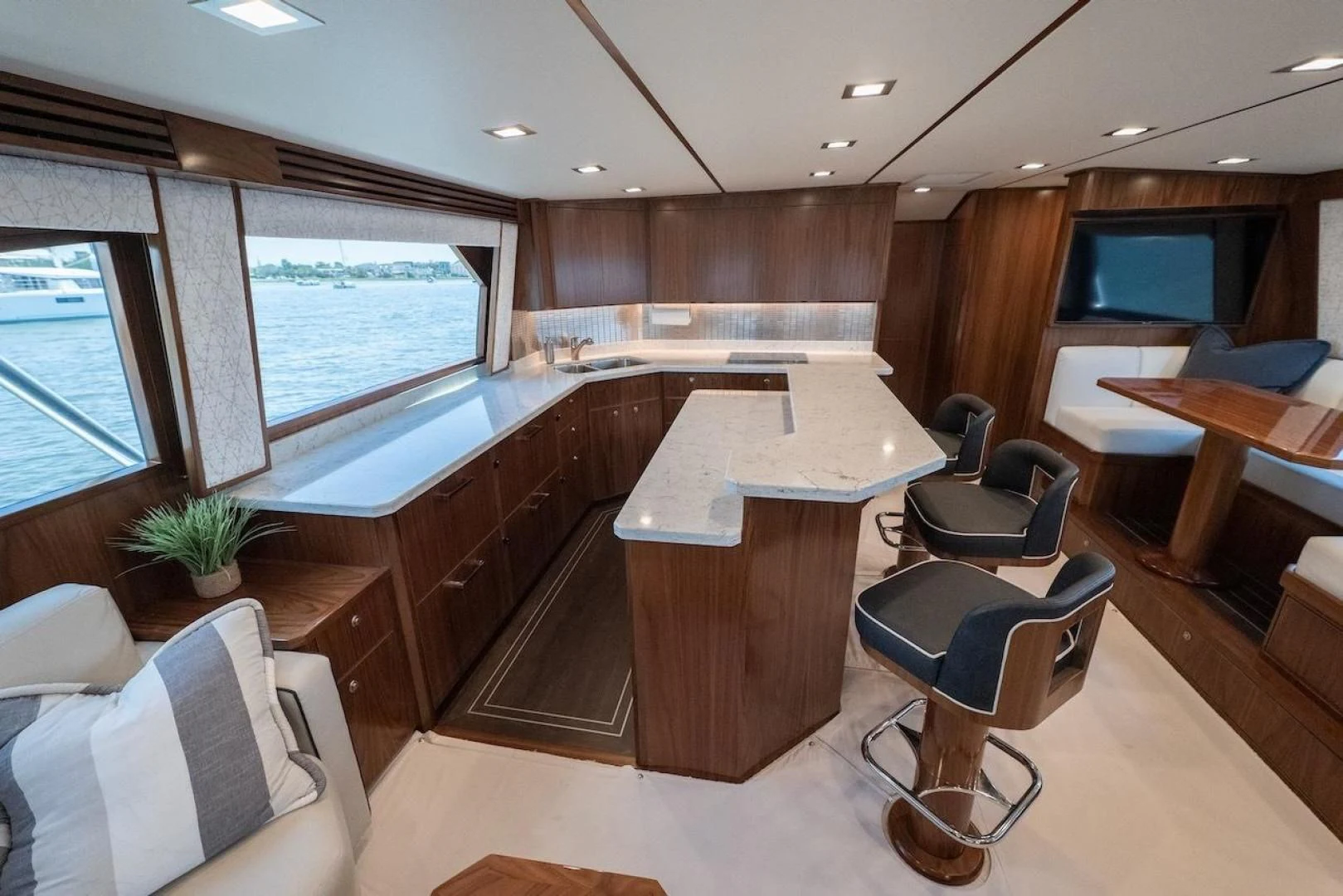 a room with a table chairs and a large window aboard GAME ON Yacht for Sale