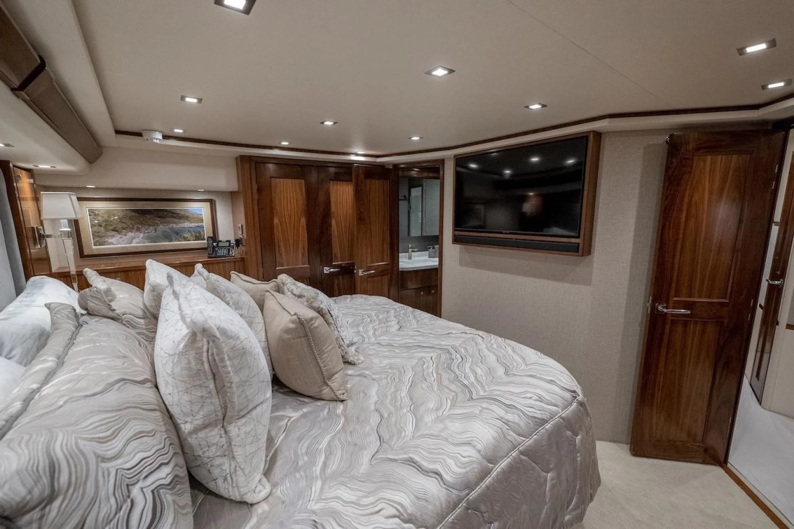 a bedroom with a bed and a television aboard GAME ON Yacht for Sale