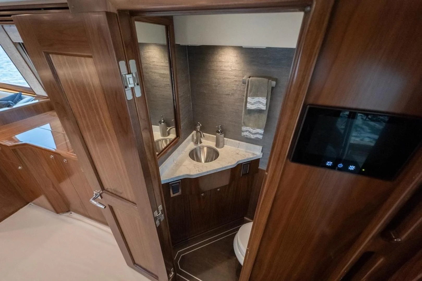 a bathroom with a sink and a tv aboard GAME ON Yacht for Sale