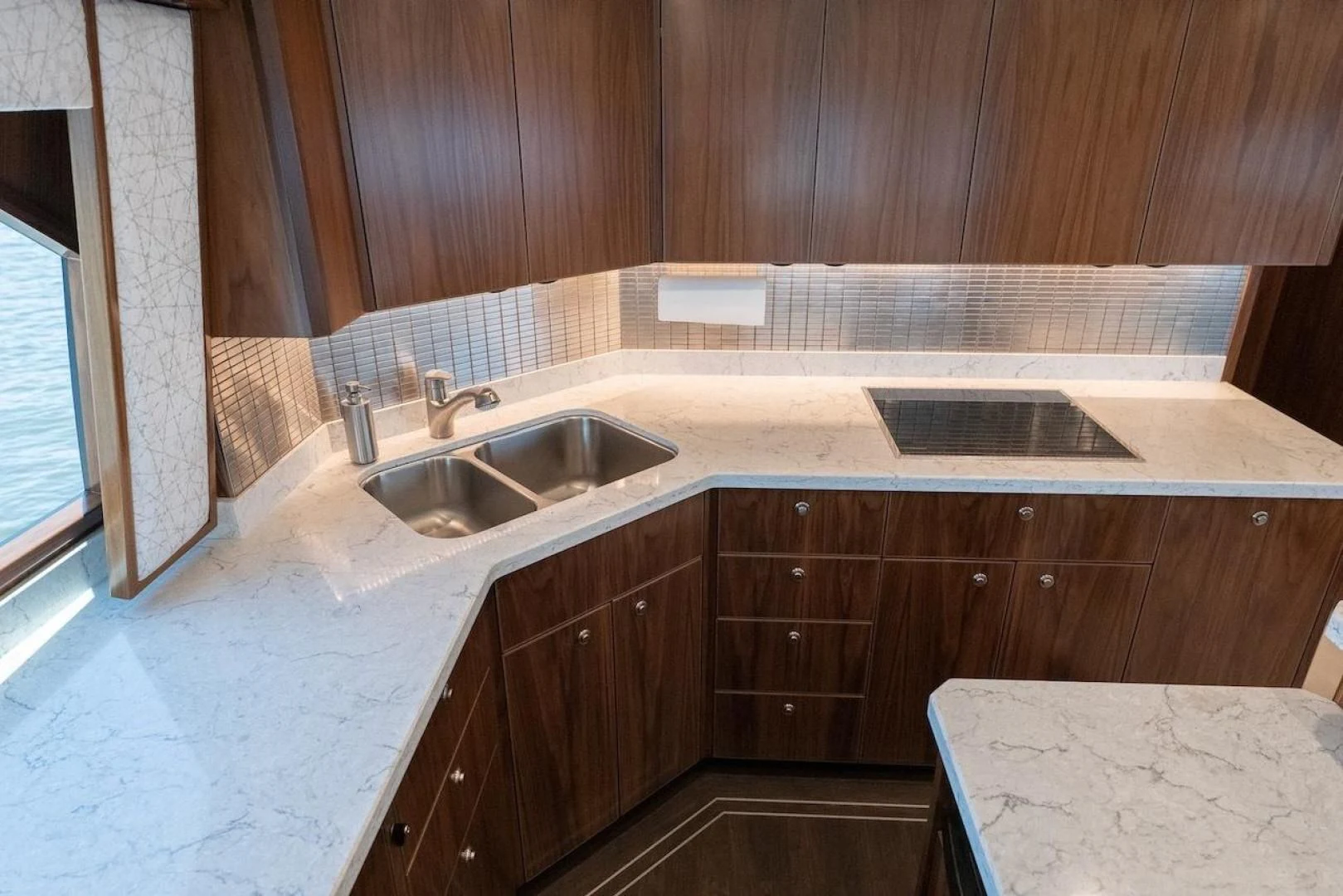 a kitchen with wooden cabinets aboard GAME ON Yacht for Sale