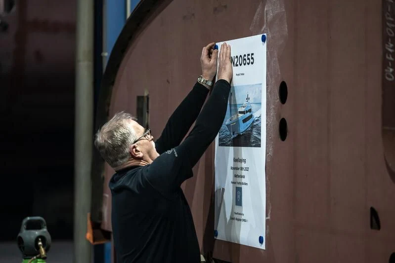 a person holding a sign aboard SOLEMATES Yacht for Sale