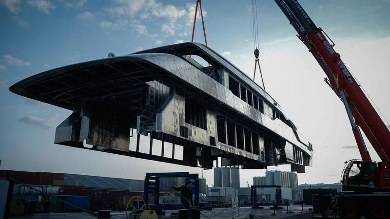 a large white building with a crane aboard SOLEMATES Yacht for Sale