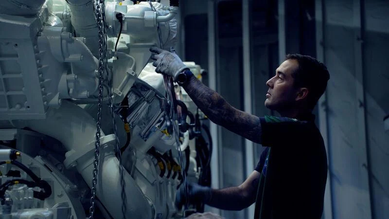 a man working on a machine aboard SOLEMATES Yacht for Sale
