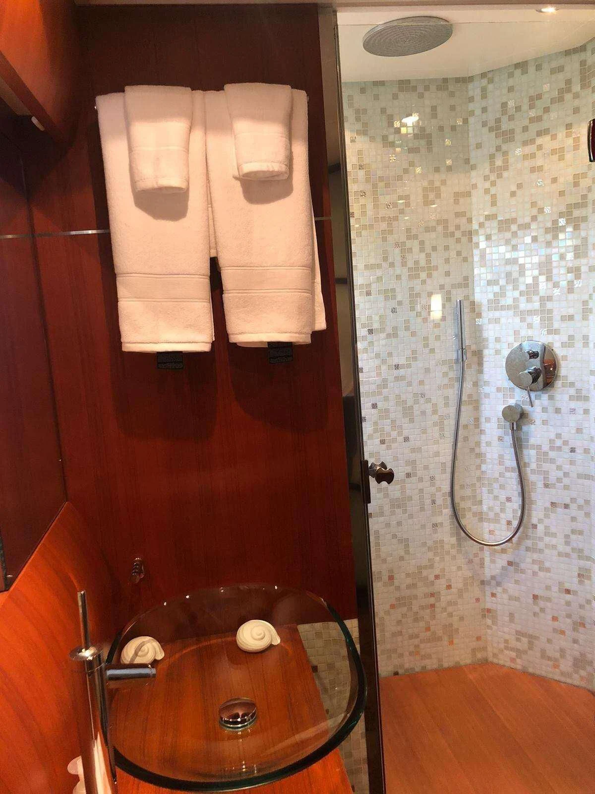 a toilet with a towel on the wall aboard REGAL Yacht for Sale