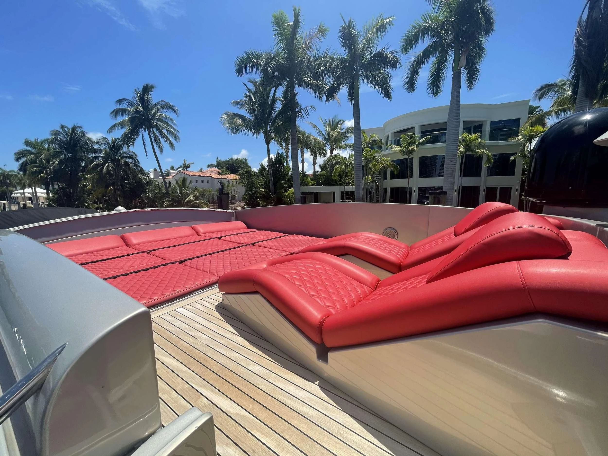 a deck with a pool and palm trees aboard REGAL Yacht for Sale