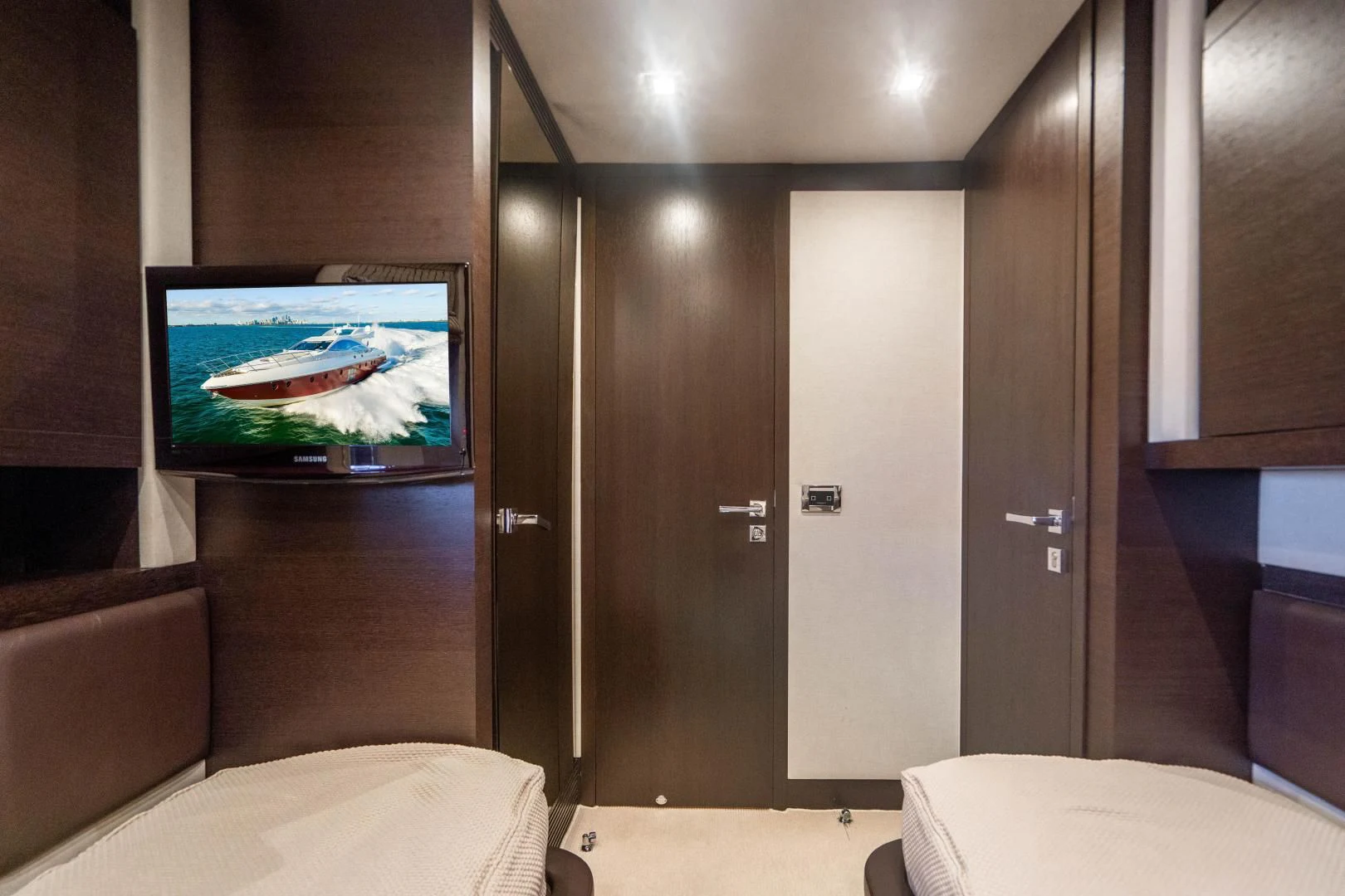 a room with a tv and a bed aboard PLANE II SEA Yacht for Sale
