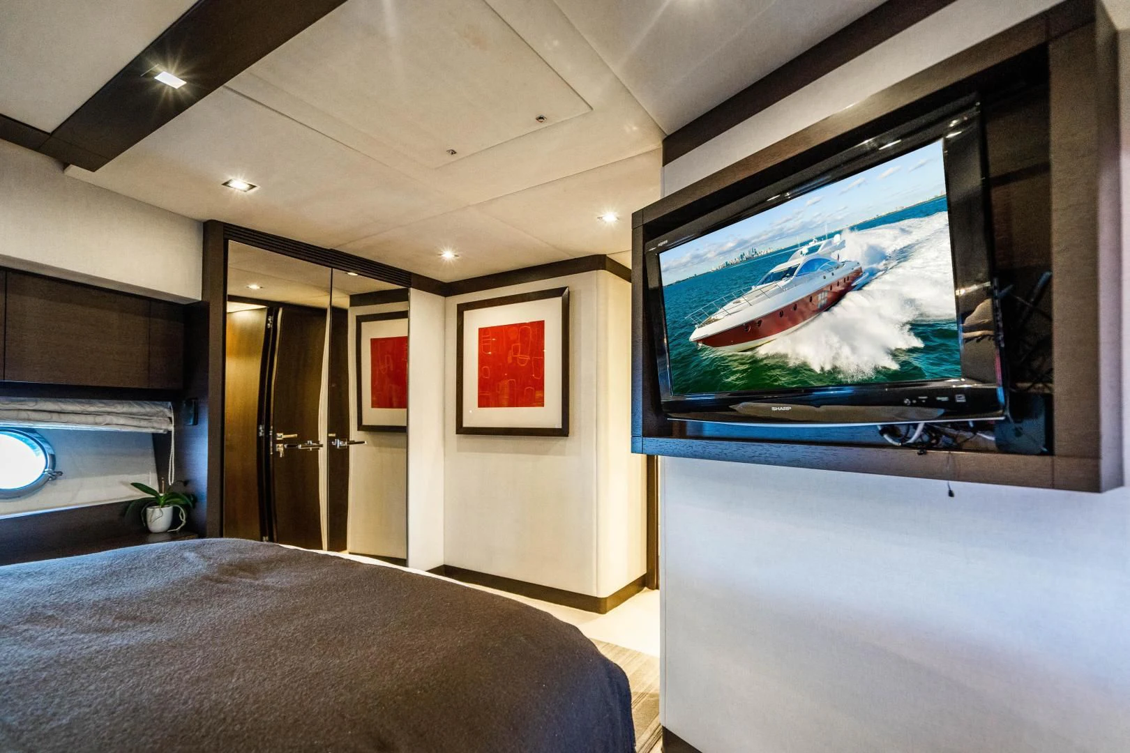 a tv on a wall aboard PLANE II SEA Yacht for Sale