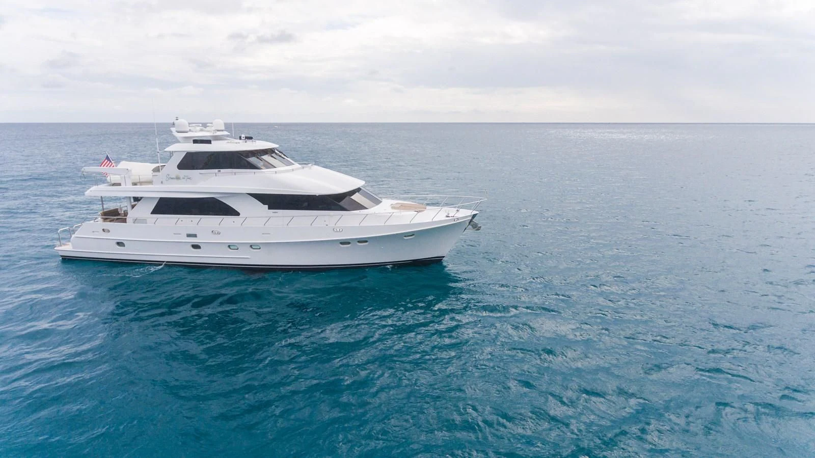 a white yacht in the water aboard SOMEWHERE IN TIME Yacht for Sale