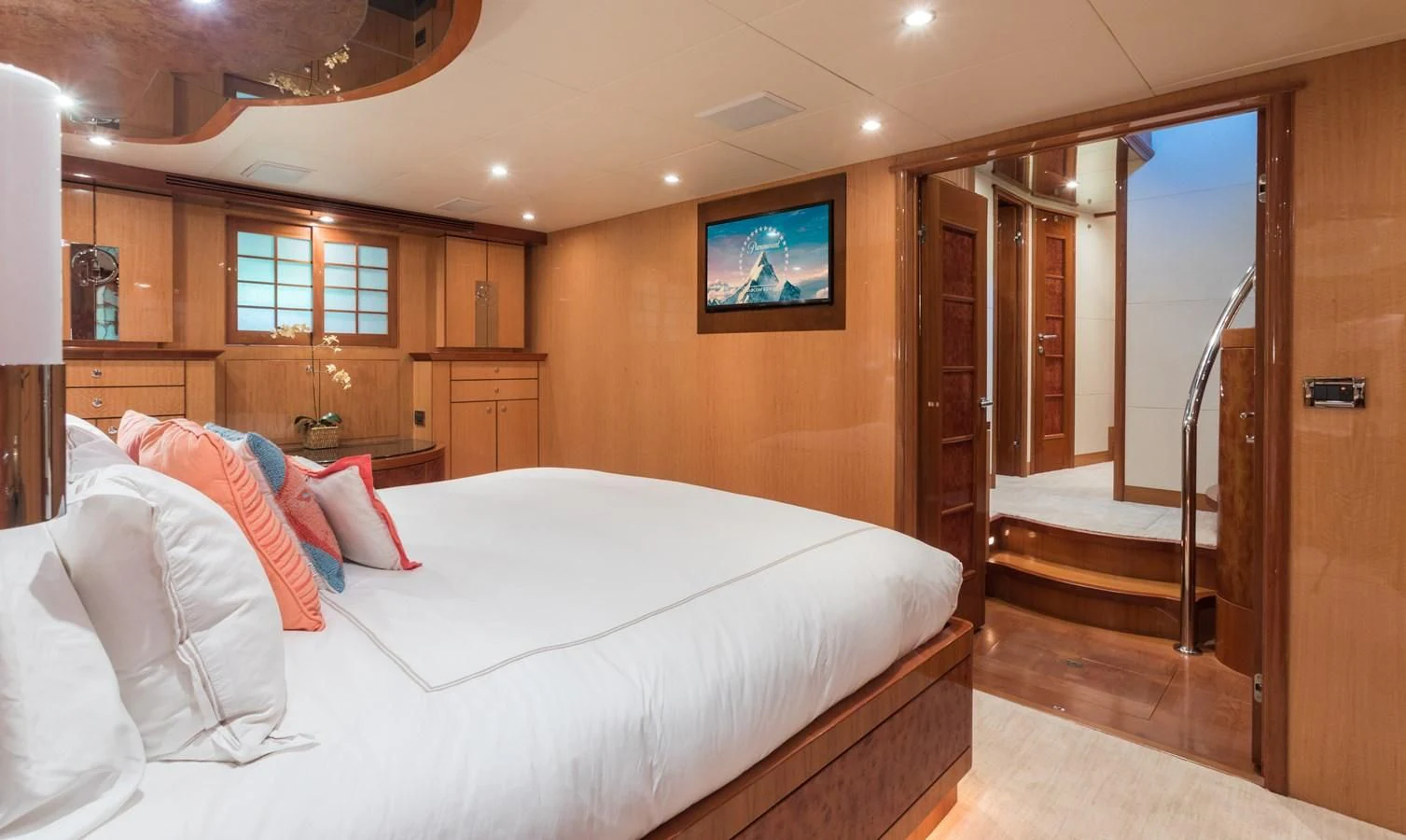 a bedroom with a bed and a mirror aboard SOMEWHERE IN TIME Yacht for Sale