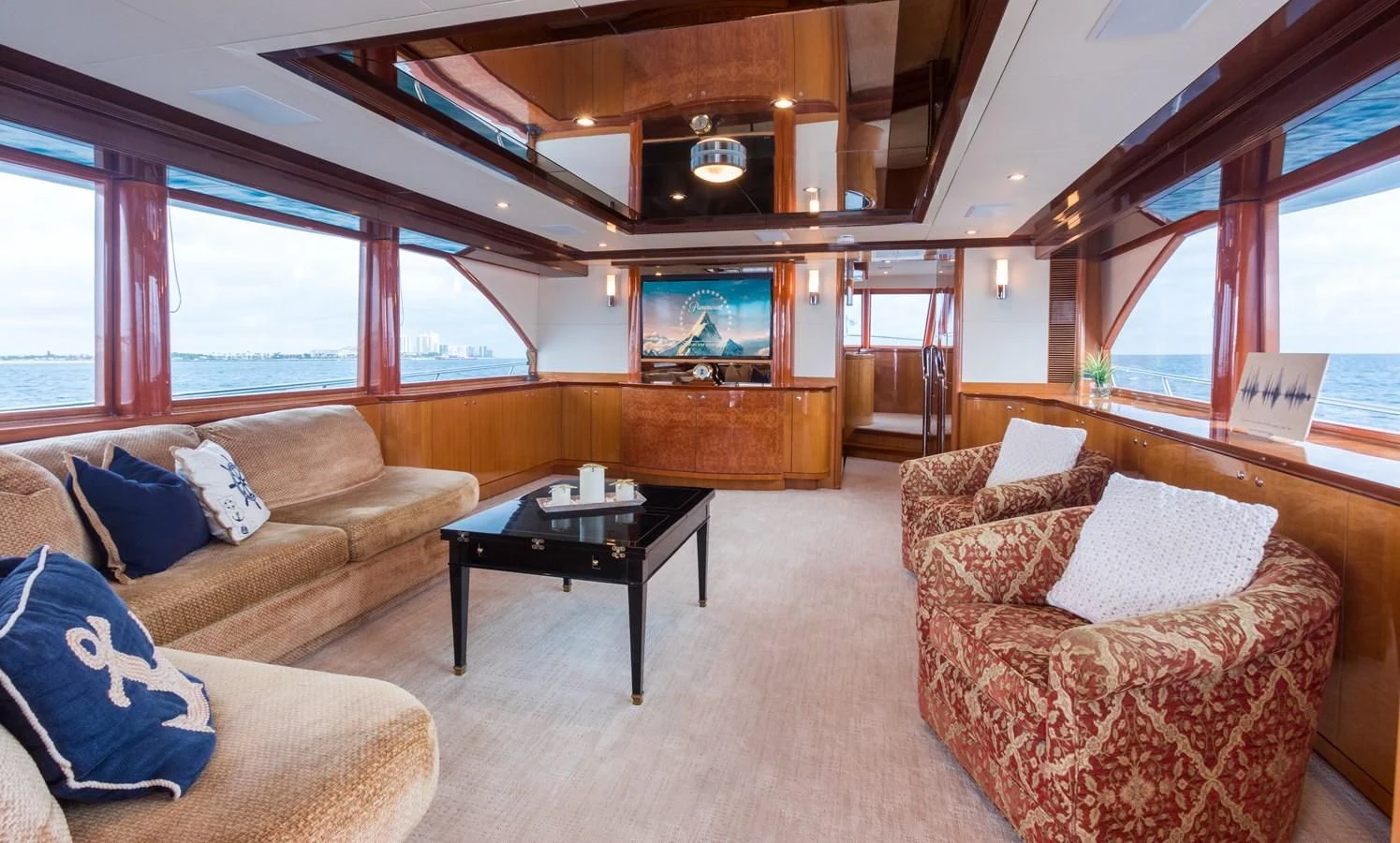a living room with a tv and couches aboard SOMEWHERE IN TIME Yacht for Sale