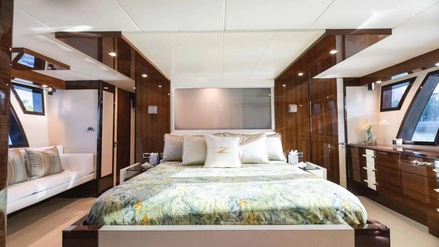 a room with a bed and a television aboard NEW LIFE Yacht for Sale