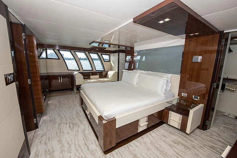 a room with a bed and a large window aboard NEW LIFE Yacht for Sale