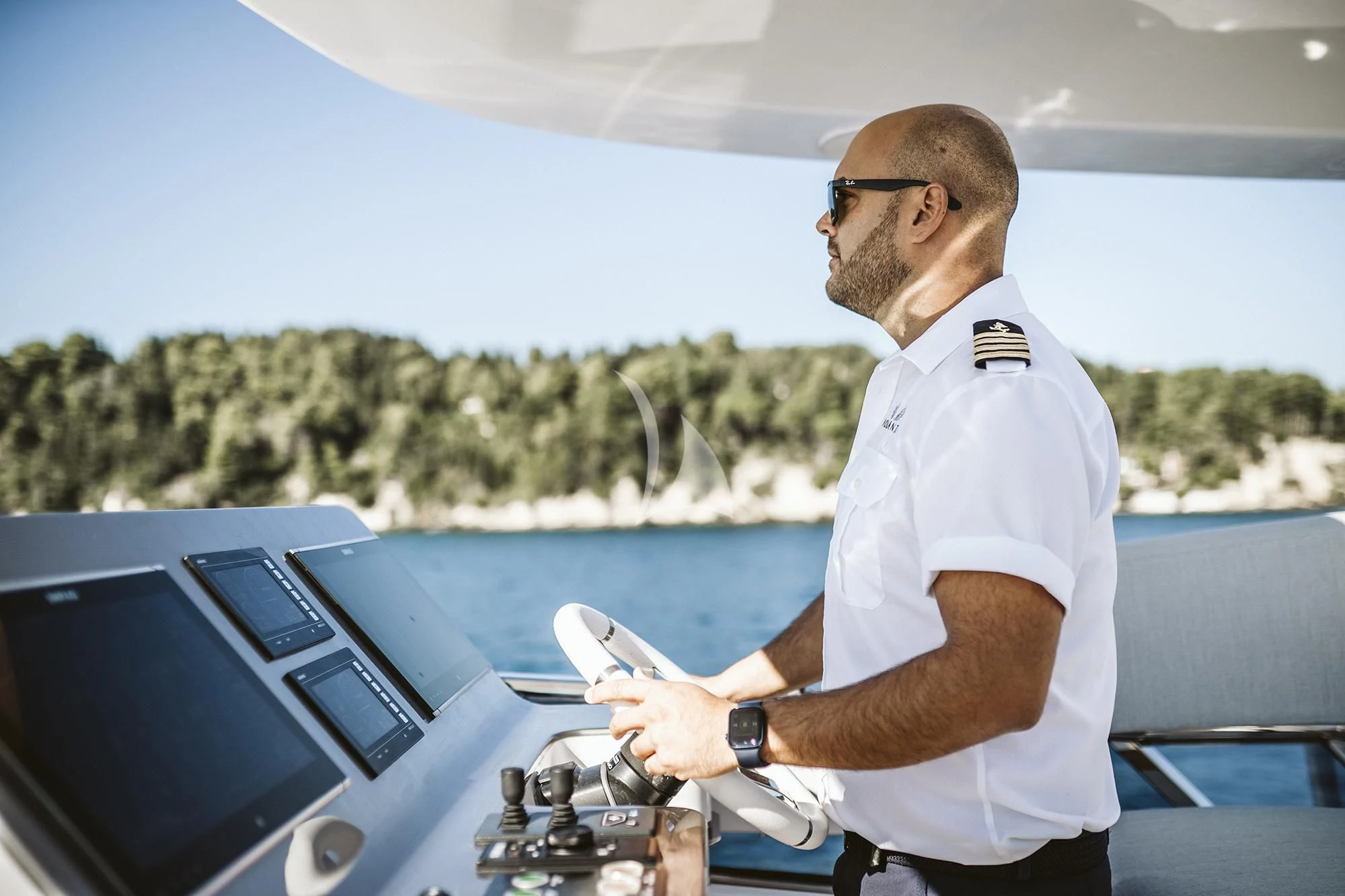 a man holding a drone aboard AGIO Yacht for Charter