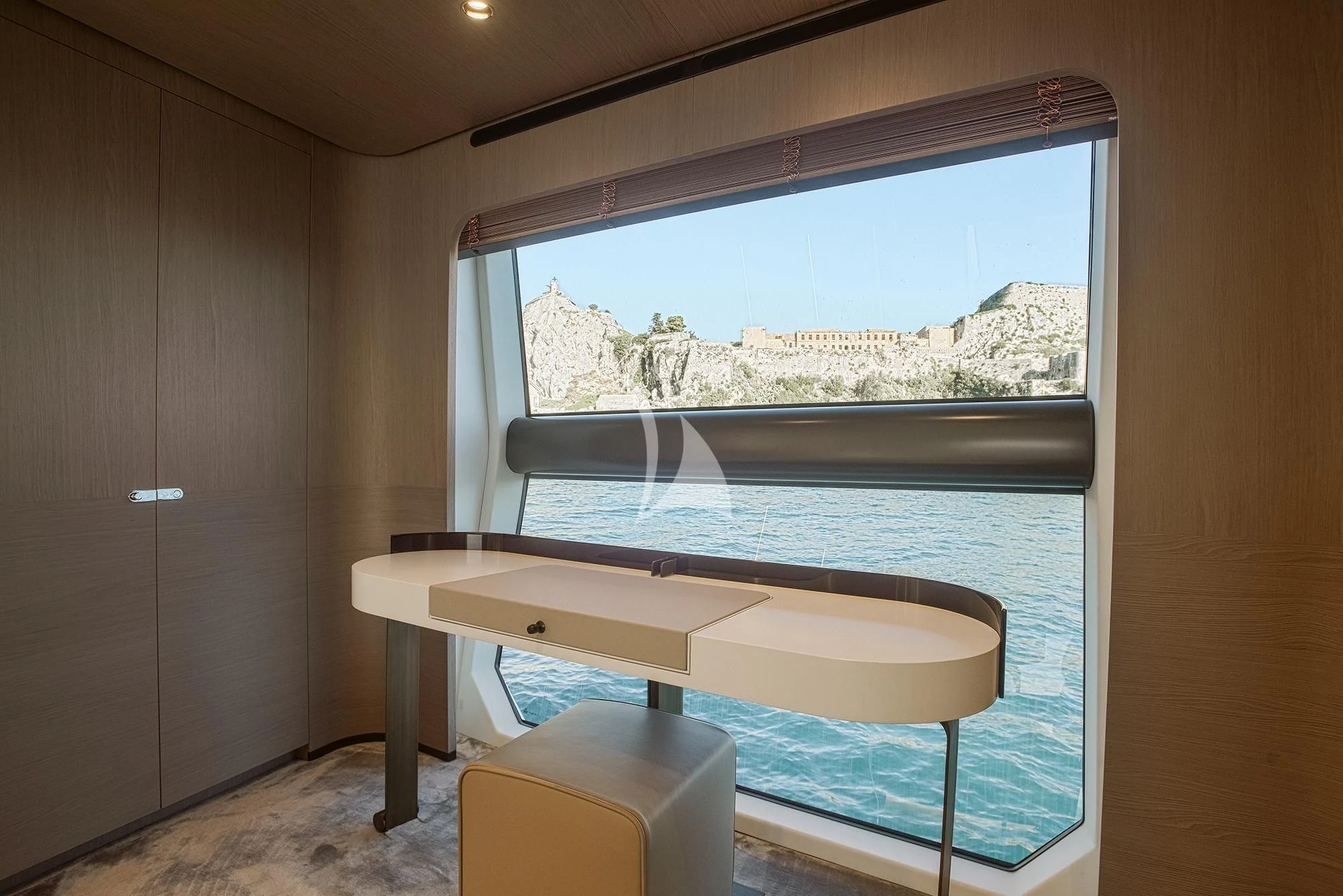 a table and a window in a room aboard AGIO Yacht for Charter