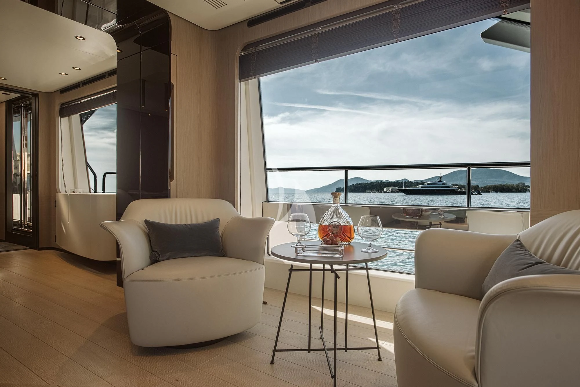 a living room with a large window aboard AGIO Yacht for Charter