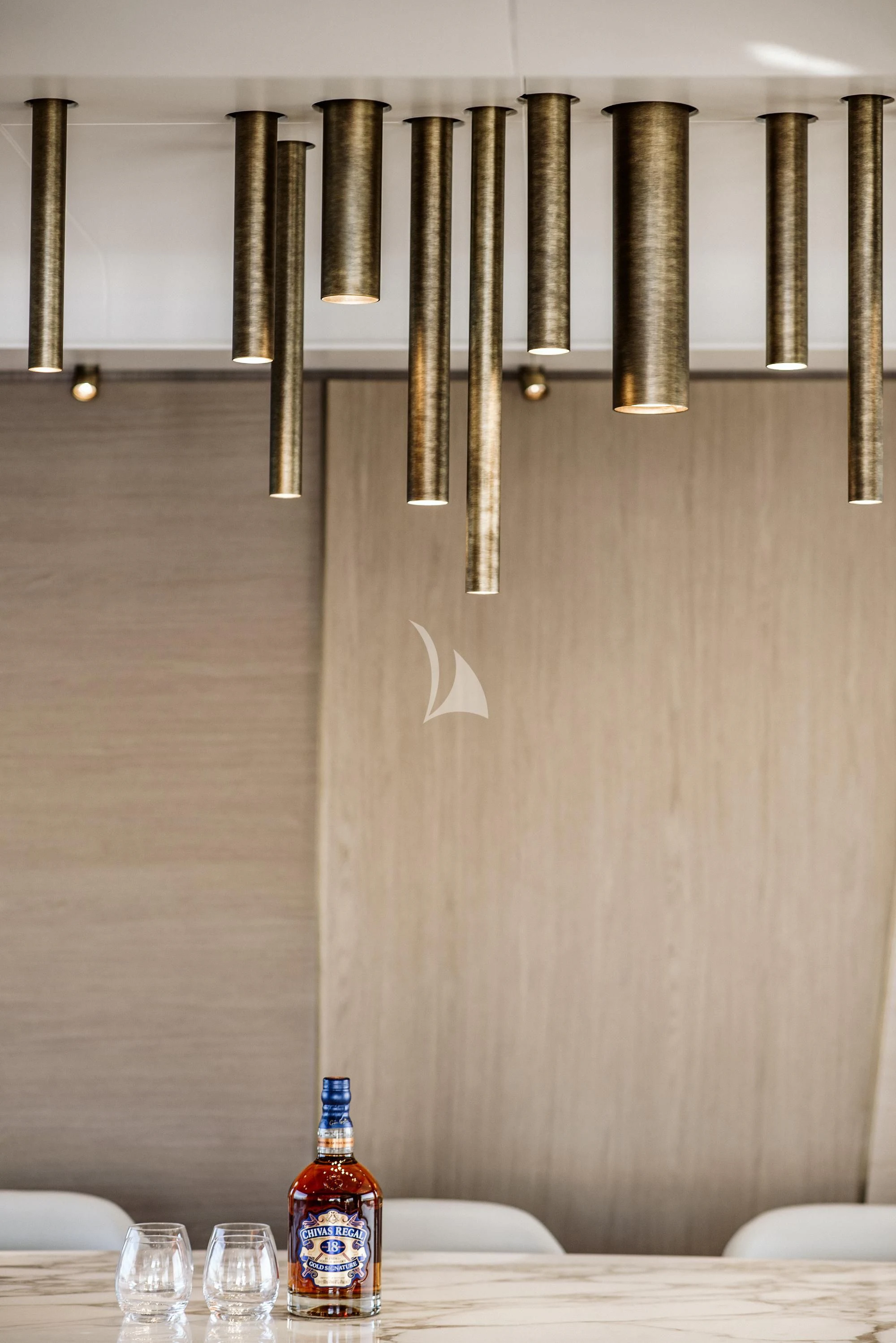 a bottle of liquid on a table aboard AGIO Yacht for Charter