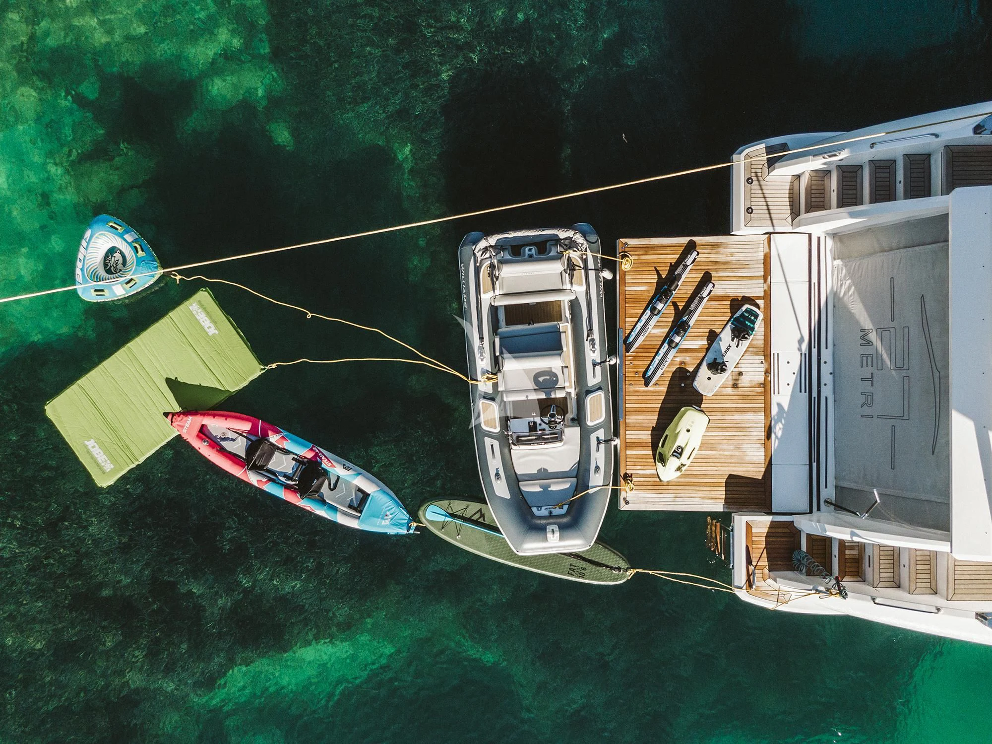 a helicopter flying over a field aboard AGIO Yacht for Charter