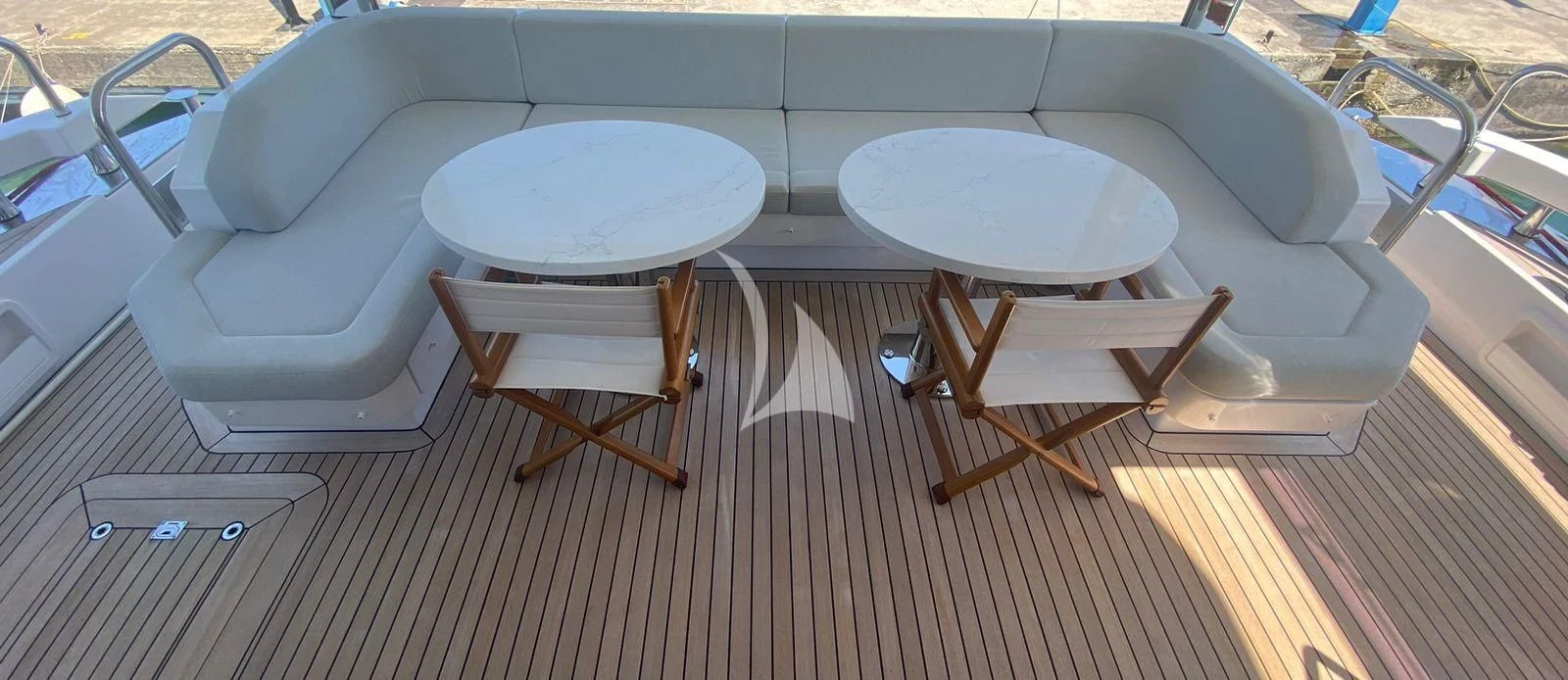 a table and chairs on a deck aboard AGIO Yacht for Charter