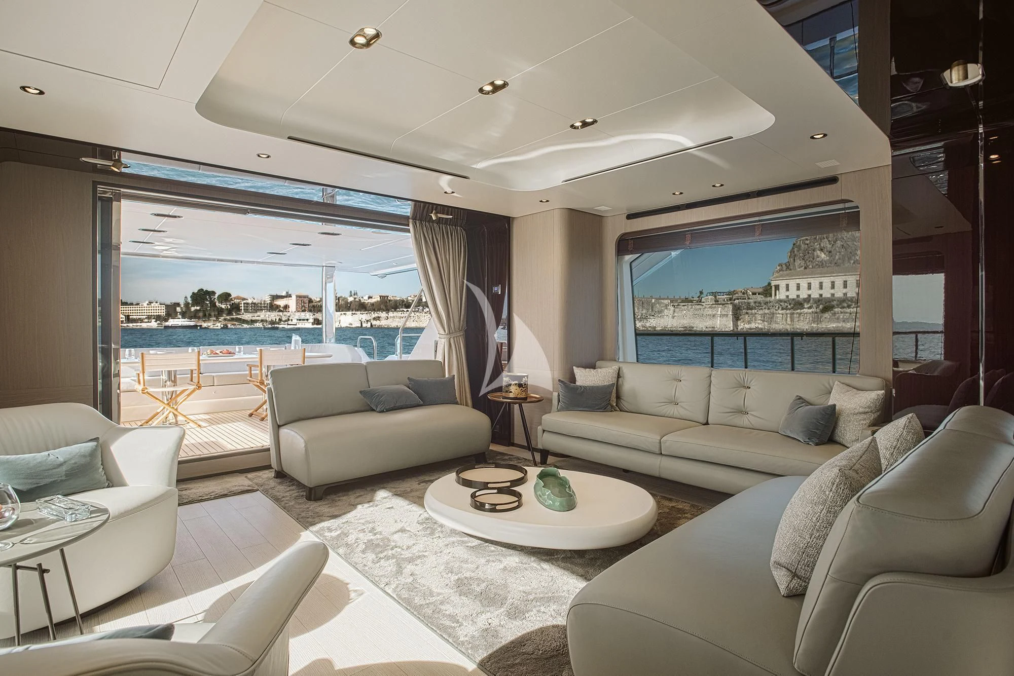 a living room with a large window aboard AGIO Yacht for Charter