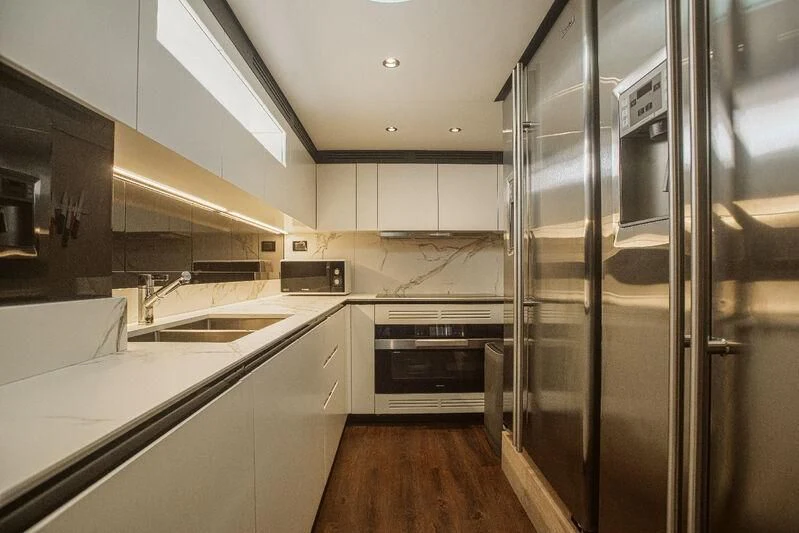 a kitchen with stainless steel appliances aboard AGIO Yacht for Charter