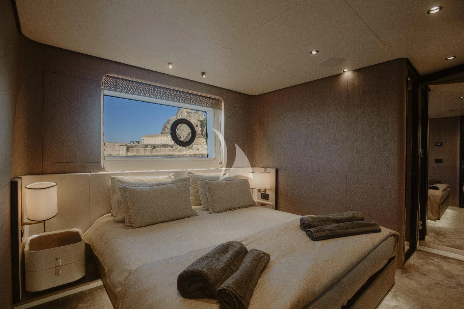 a bed with a painting on the wall aboard AGIO Yacht for Charter