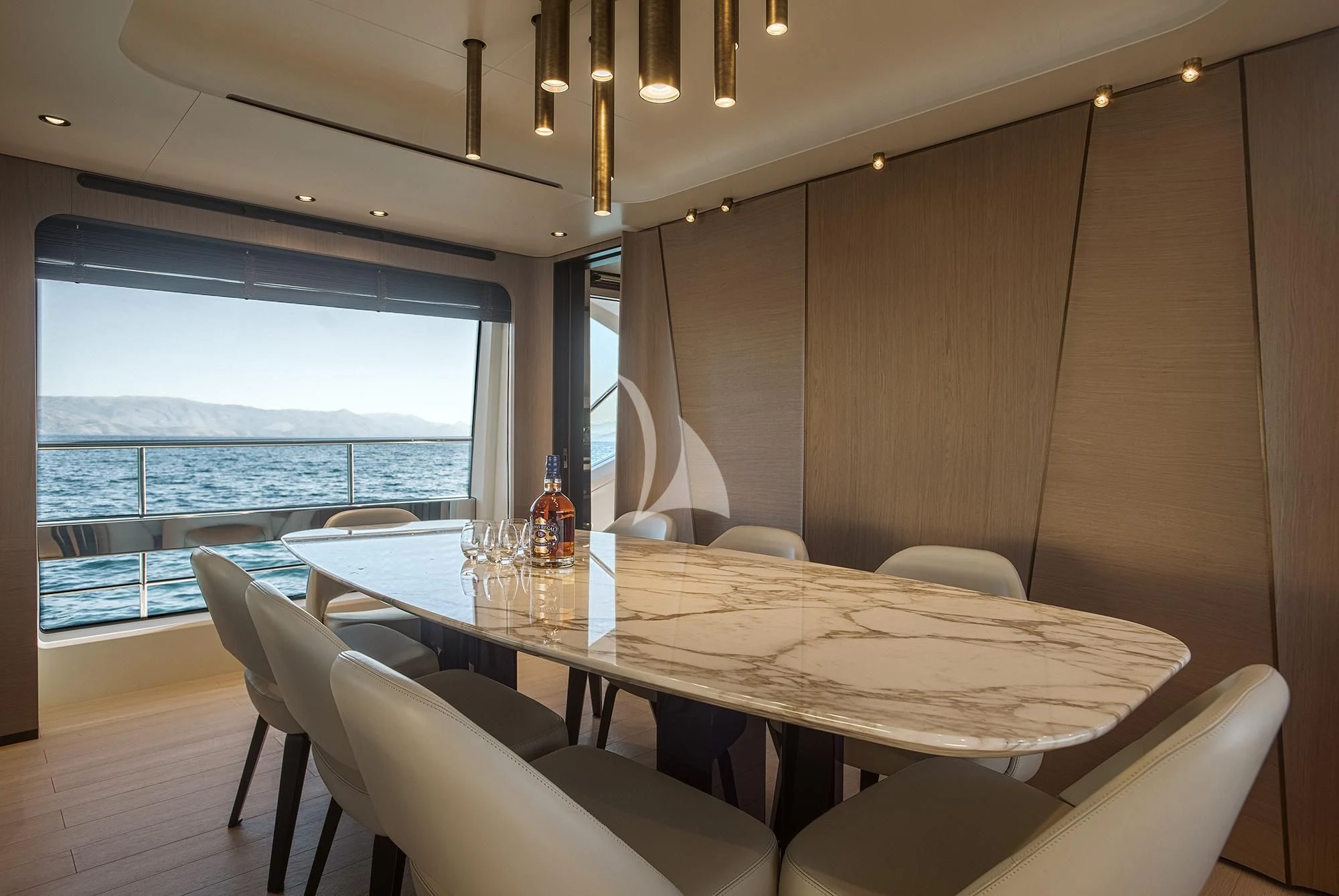 a table with chairs around it aboard AGIO Yacht for Charter