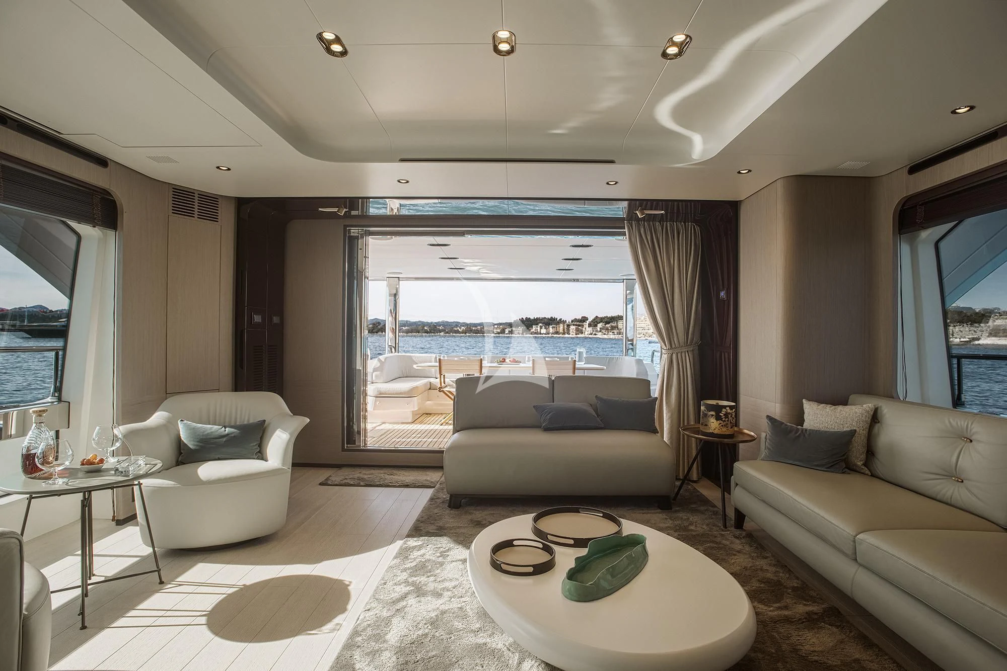 a living room with a large window aboard AGIO Yacht for Charter