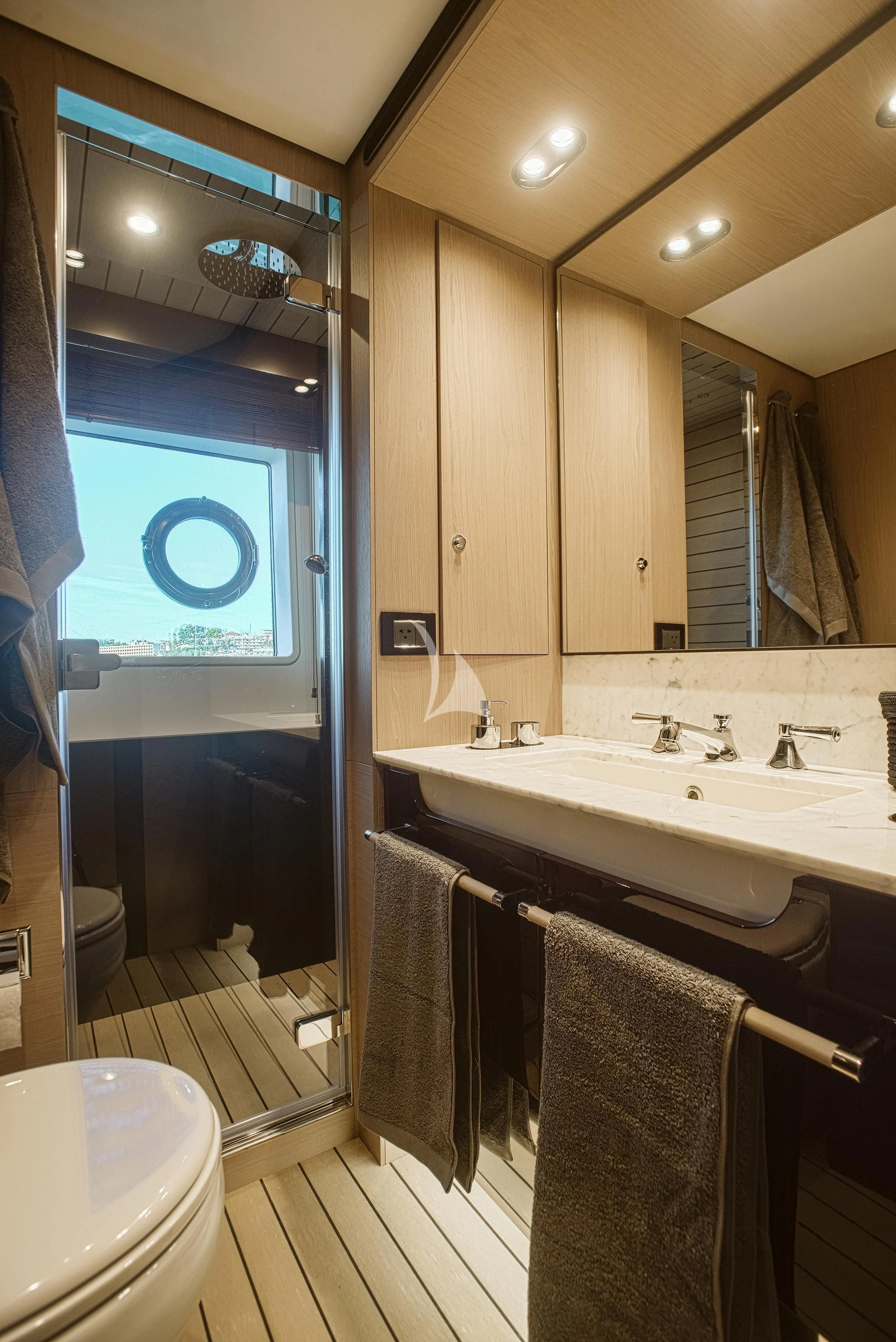 a bathroom with a sink and a mirror aboard AGIO Yacht for Charter
