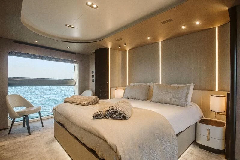 a hotel room with a bed and a window aboard AGIO Yacht for Charter