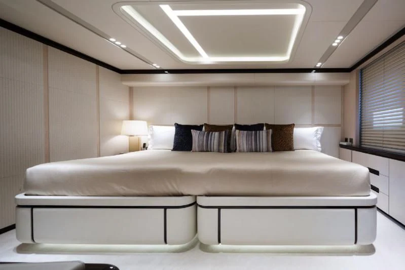a bed with a white bed spread aboard LADY A Yacht for Sale