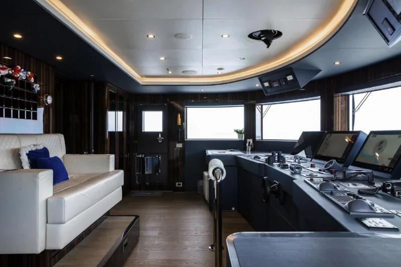 a room with a couch and a table with computers aboard LADY A Yacht for Sale