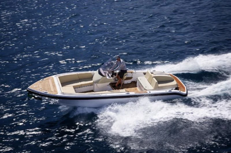 a person driving a speed boat aboard LADY A Yacht for Sale