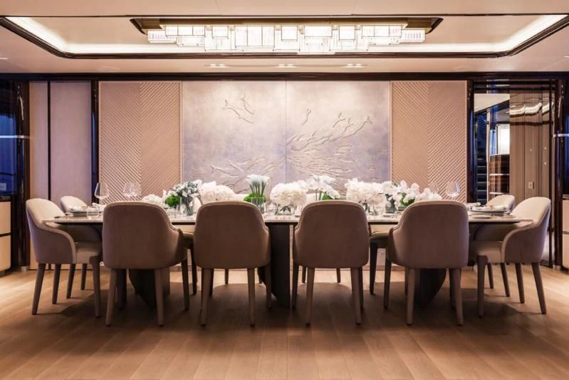 a room with a table and chairs aboard LADY A Yacht for Sale