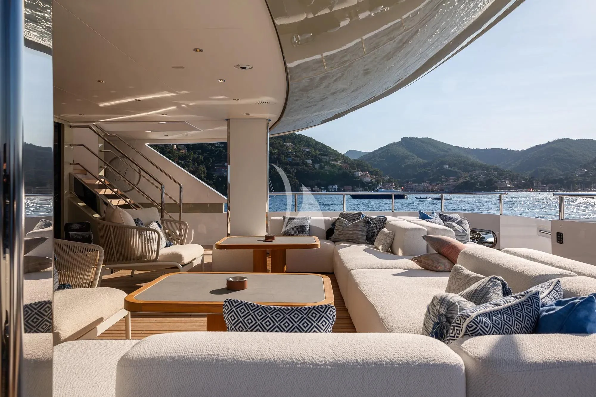 a room with a couch and a table and a large body of water aboard LADY A Yacht for Sale