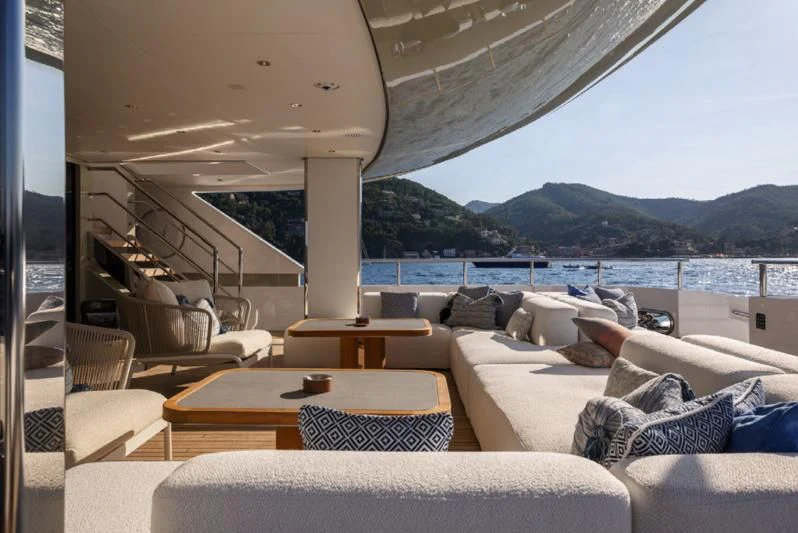 a living room with a large body of water in the background aboard LADY A Yacht for Sale