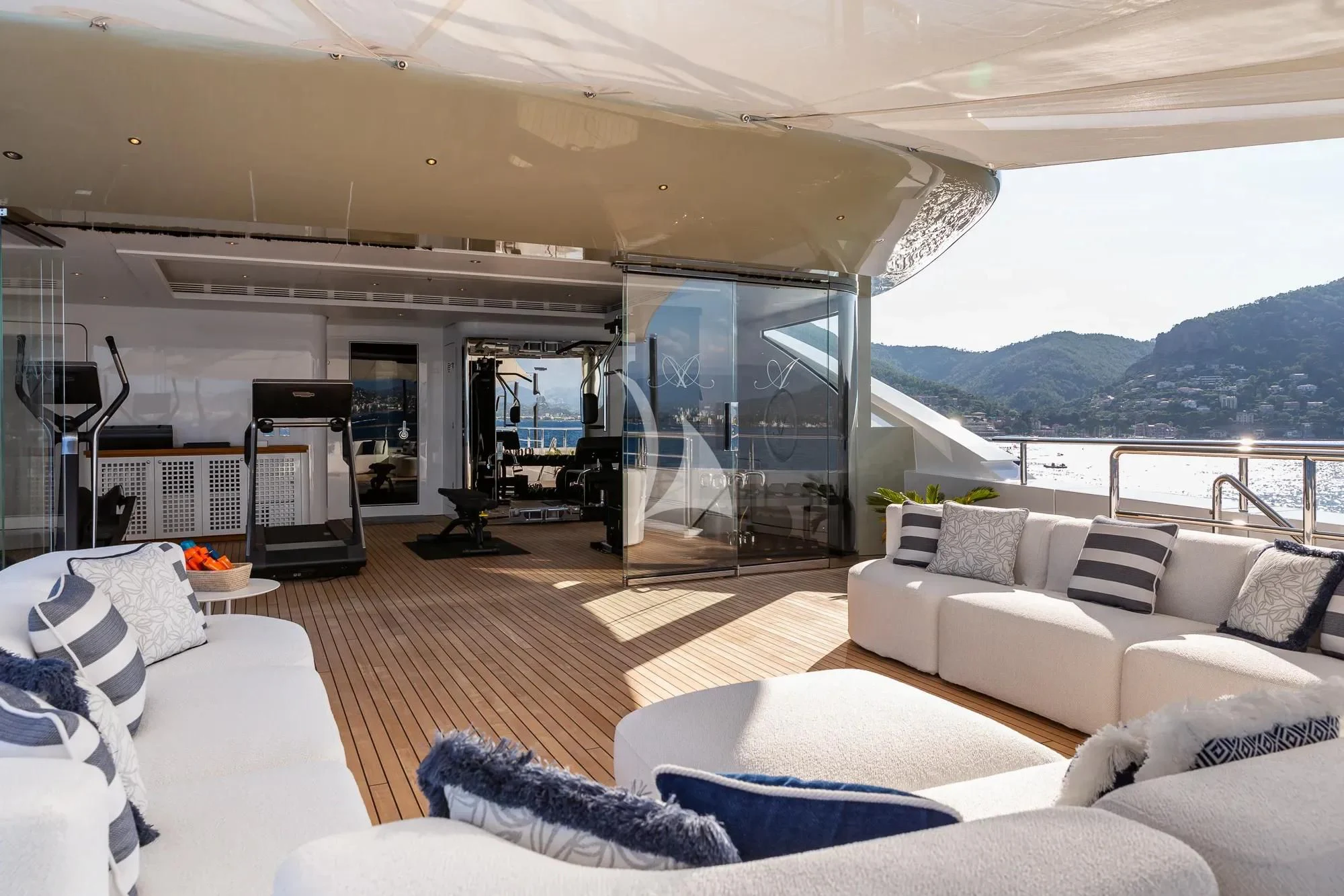 a living room with a large glass door aboard LADY A Yacht for Sale