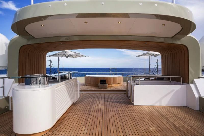 a large white tent with a deck and a large body of water aboard LADY A Yacht for Sale