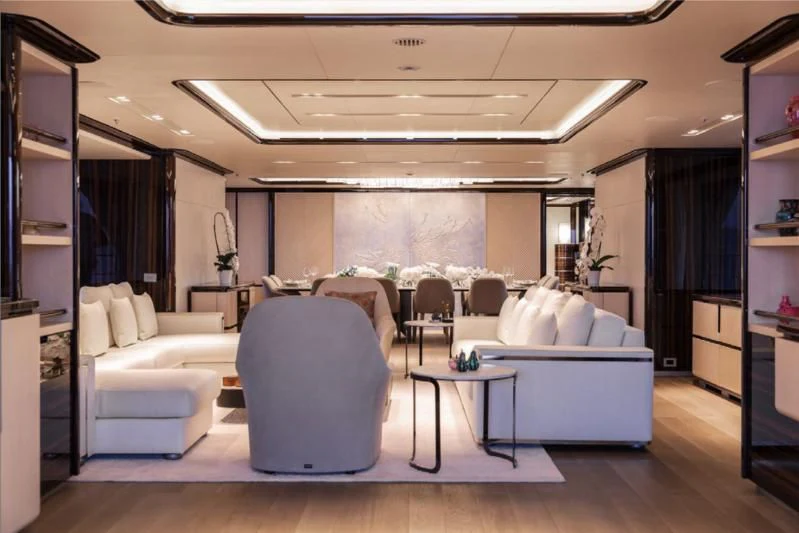 a room with white couches and a table aboard LADY A Yacht for Sale