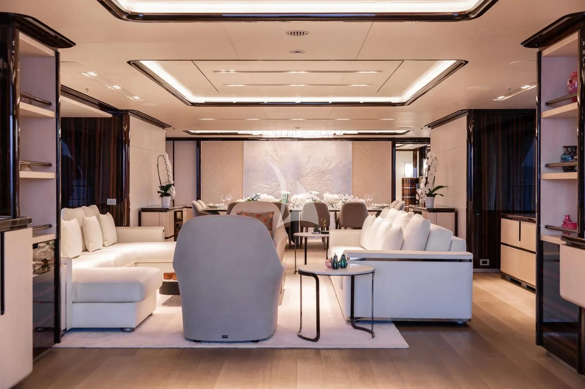 a room with white couches and a table aboard LADY A Yacht for Sale