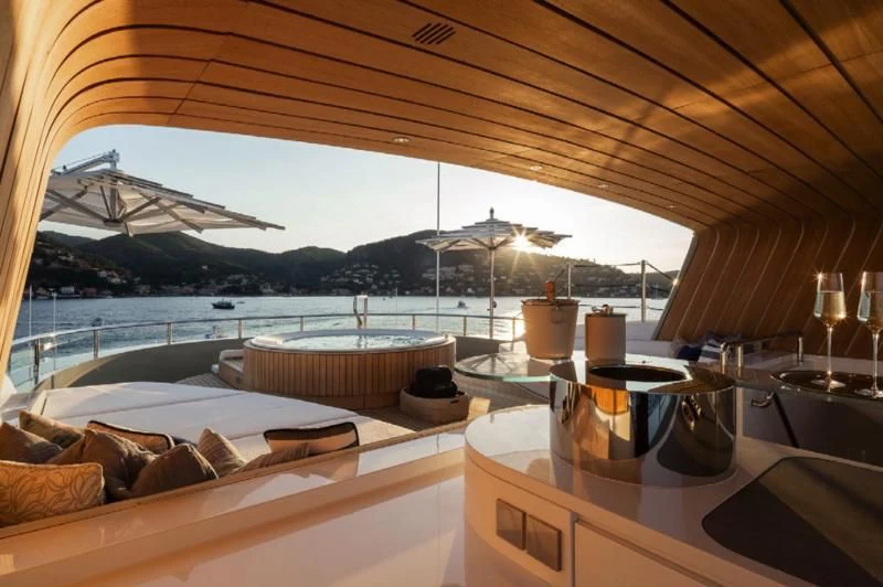 a room with a view of the water and a large boat in the distance aboard LADY A Yacht for Sale