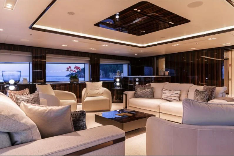 a living room with a large screen aboard LADY A Yacht for Sale