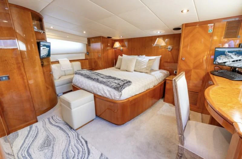 a bedroom with a bed and a desk aboard ENDLESS SUN Yacht for Sale