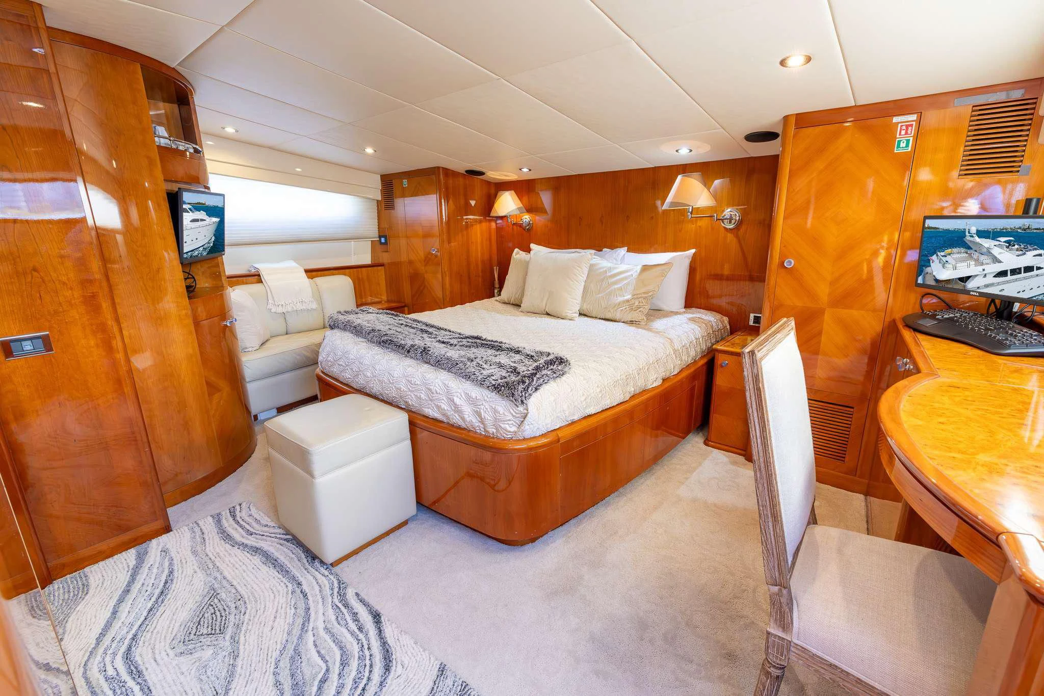 a room with a bed and desk aboard ENDLESS SUN Yacht for Sale