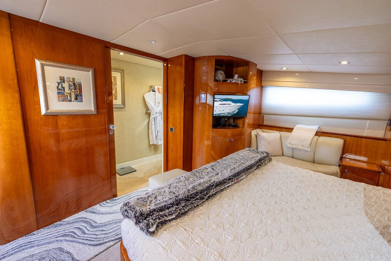 a bedroom with a bed and a mirror aboard ENDLESS SUN Yacht for Sale