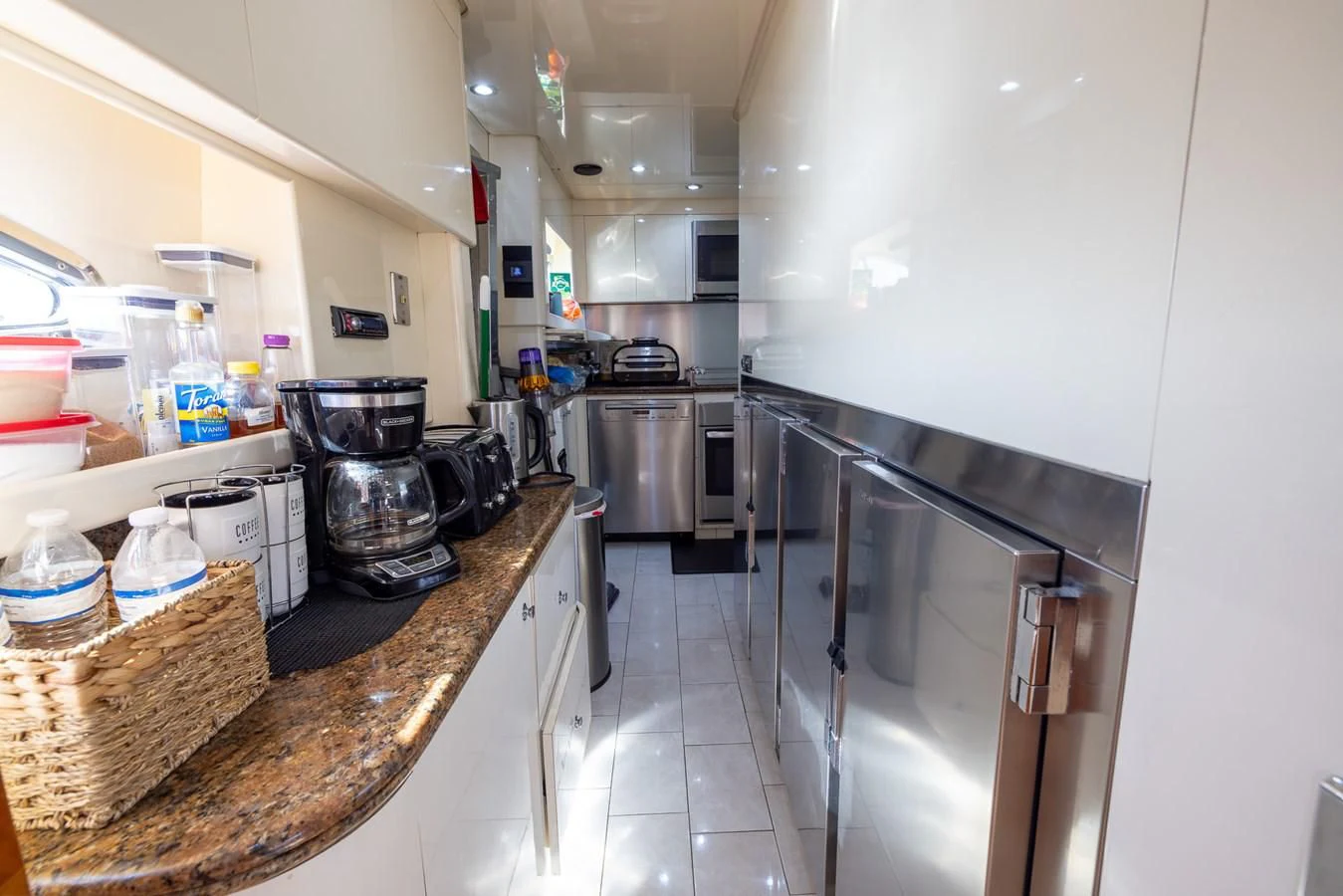 a kitchen with stainless steel appliances aboard ENDLESS SUN Yacht for Sale